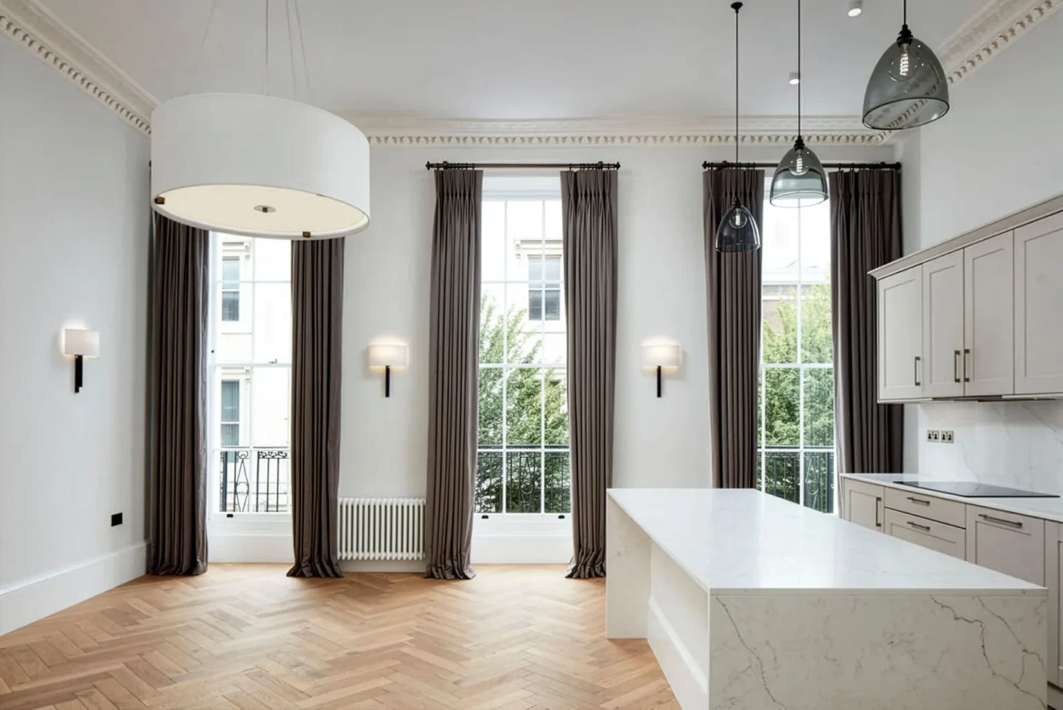 Elegant living space by FT Architects with tall sash windows, period cornicing and herringbone parquet floor