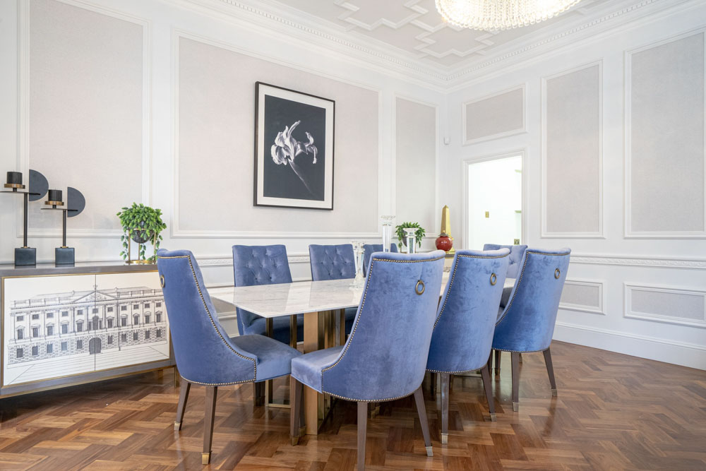 ft-architects-aldford-street-dining-room Panelled dining room with blue velvet chairs, marble table and framed botanical artwork