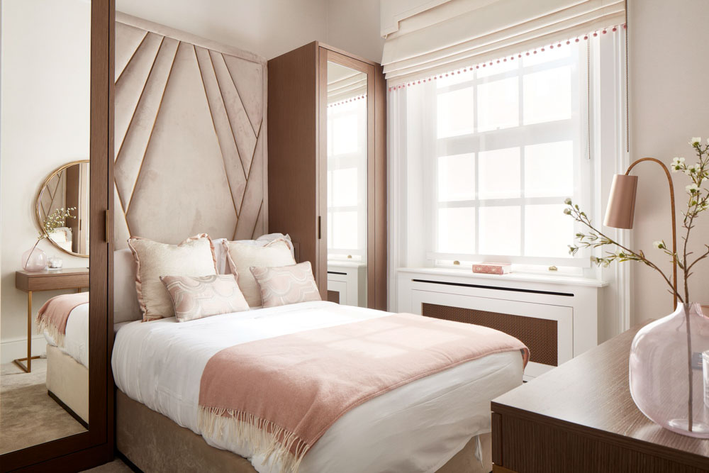 ft-architects-ovington-square-bedroom Blush-toned bedroom with upholstered fan-detail headboard and fitted timber wardrobes
