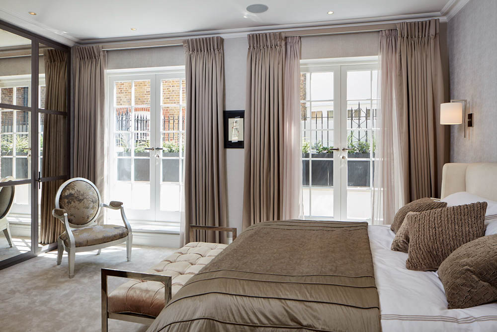 ft-architects-rex-place-bedroom Taupe principal bedroom with French doors to Juliet balconies and upholstered bench, interiors by Juliette Byrne